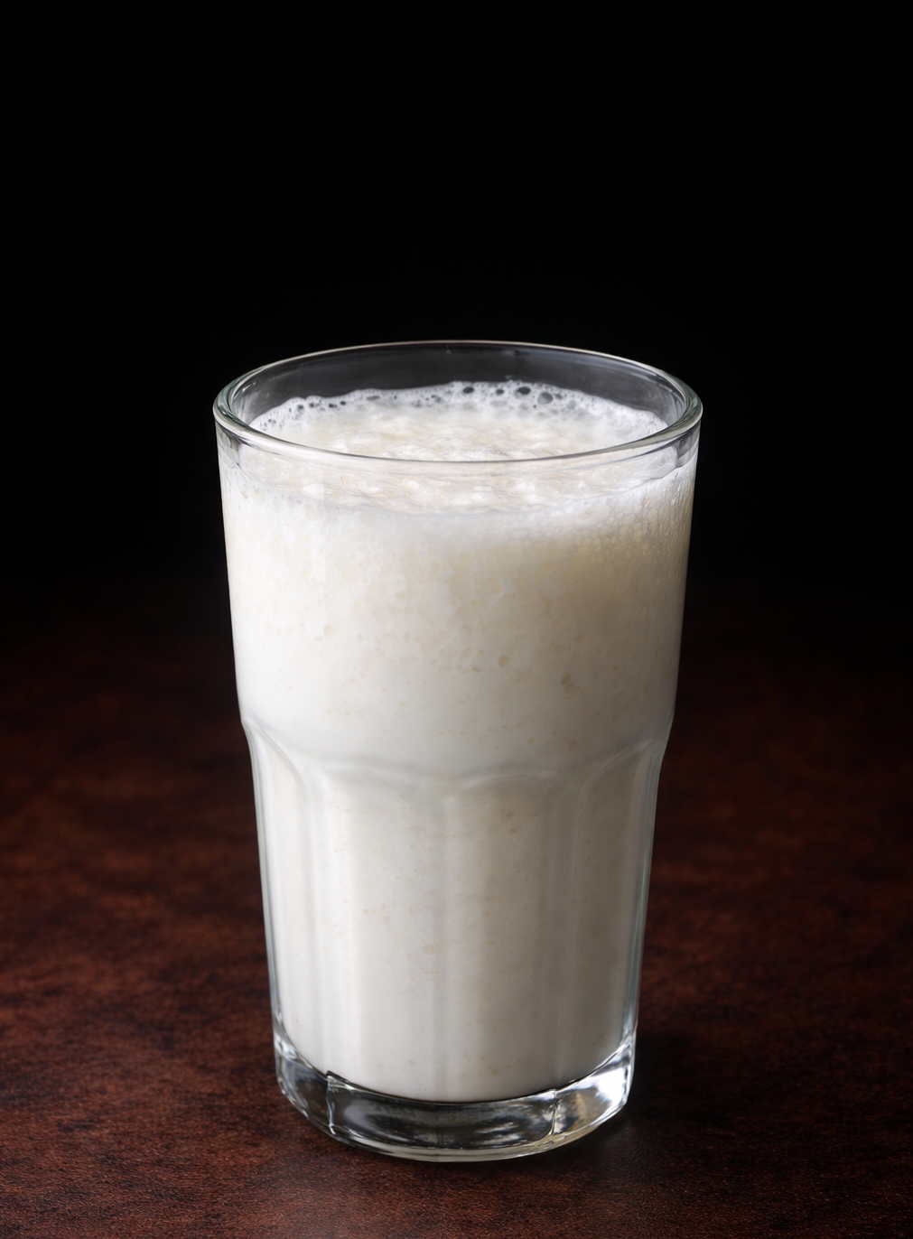 homemade milk kefir in a glass jar showing fermentation texture
